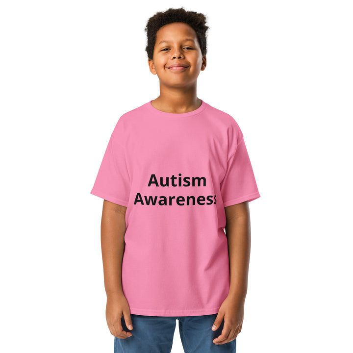 Kid wearing azalea (pink) colored t-shirt with black wording “Autism Awareness”