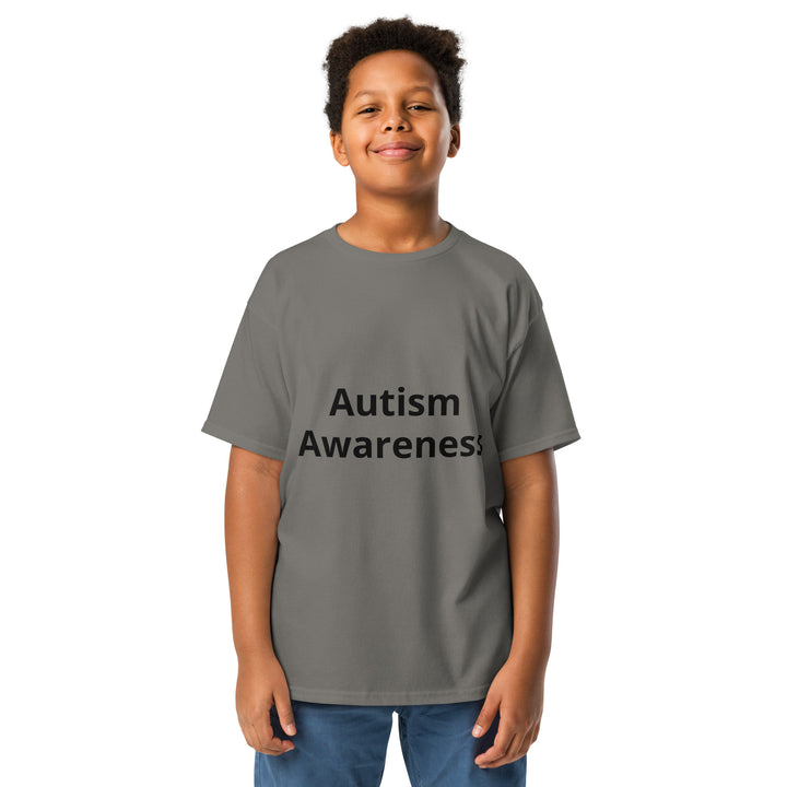 Kid wearing charcoal colored t-shirt with black wording “Autism Awareness”